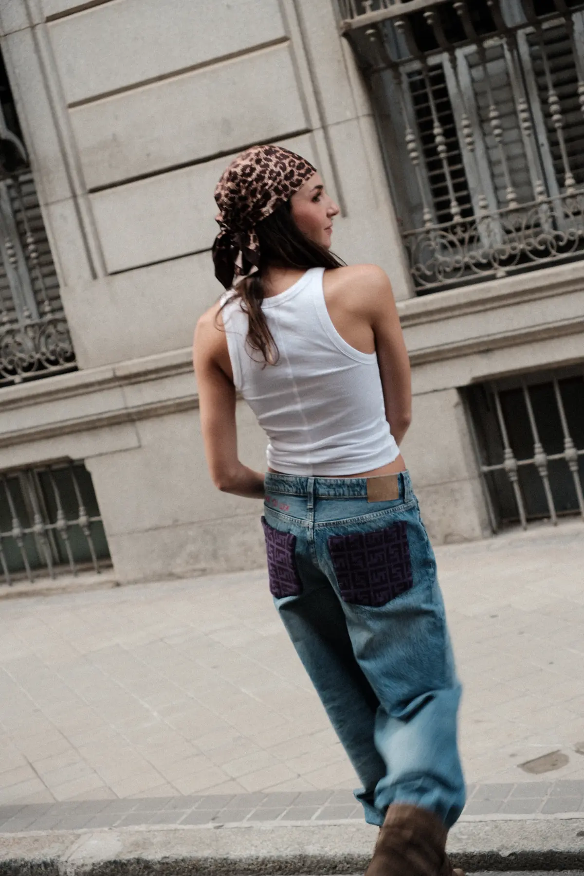 Parché Studio cropped jacket with a monogram patch, worn with zebra trousers