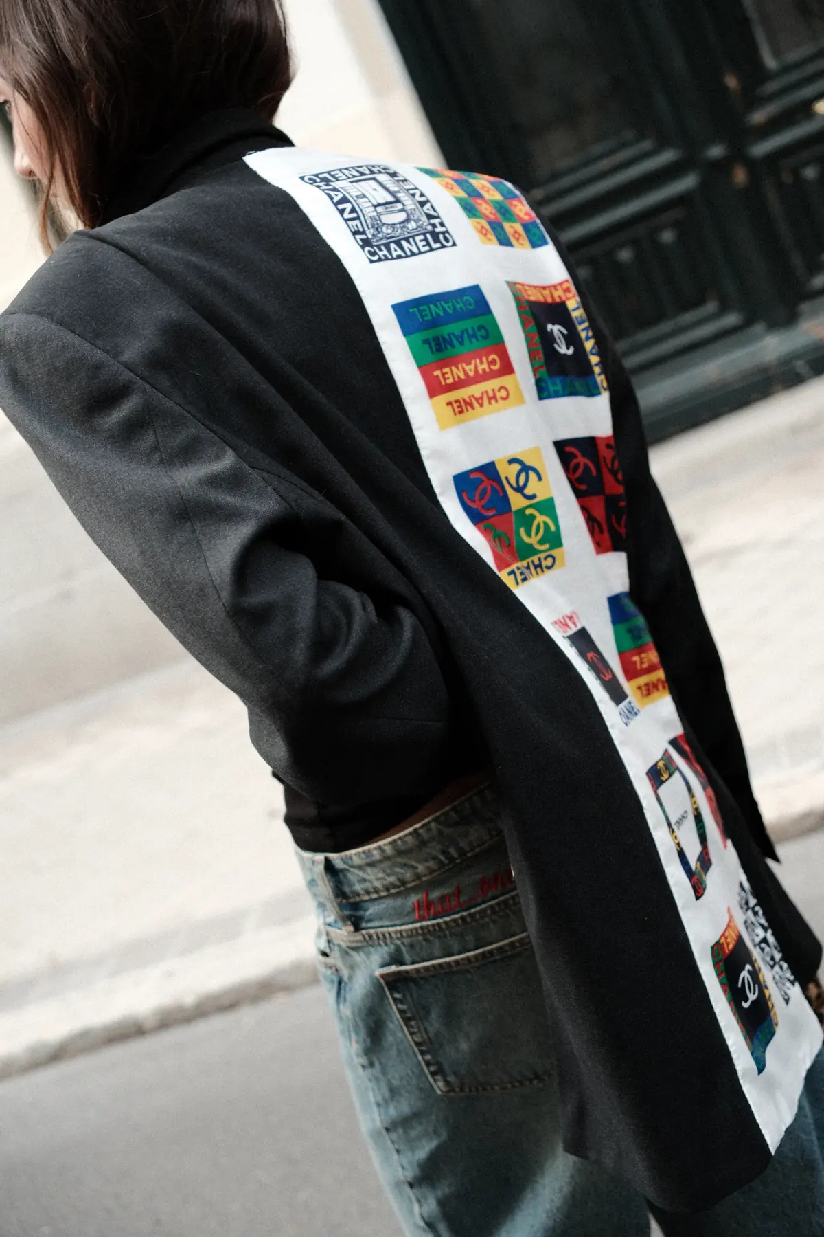 Parché Studio jeans with purple monogram patch pockets, worn on a Madrid street